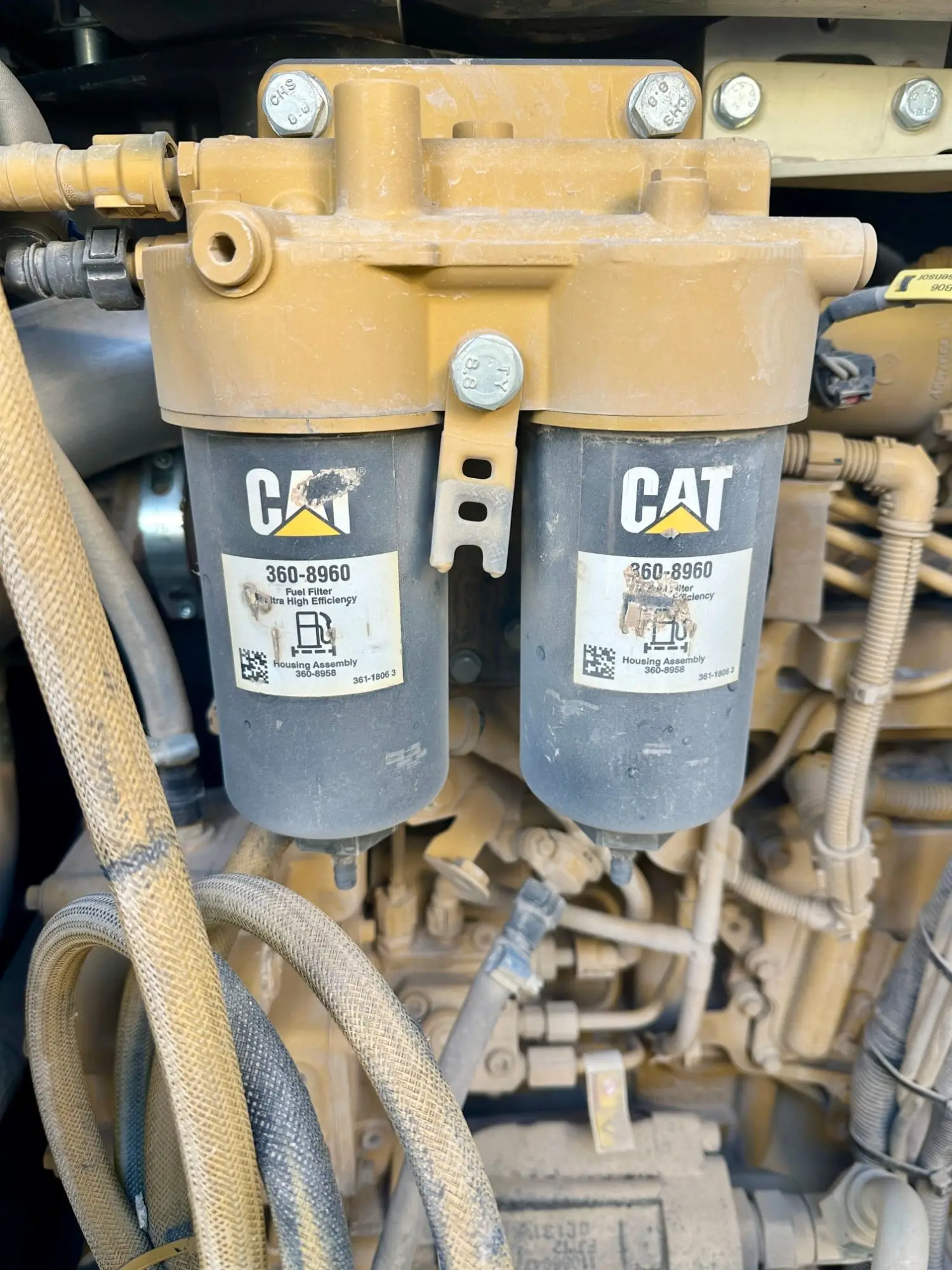 Twin Cat fuel filters mounted on a heavy equipment engine